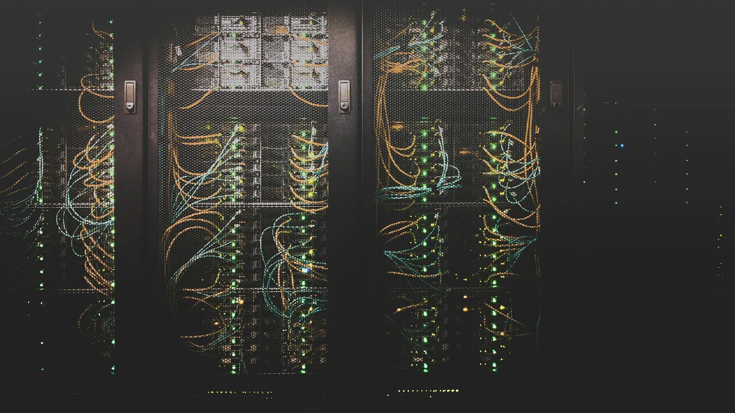 Dark server racks with glowing network cables